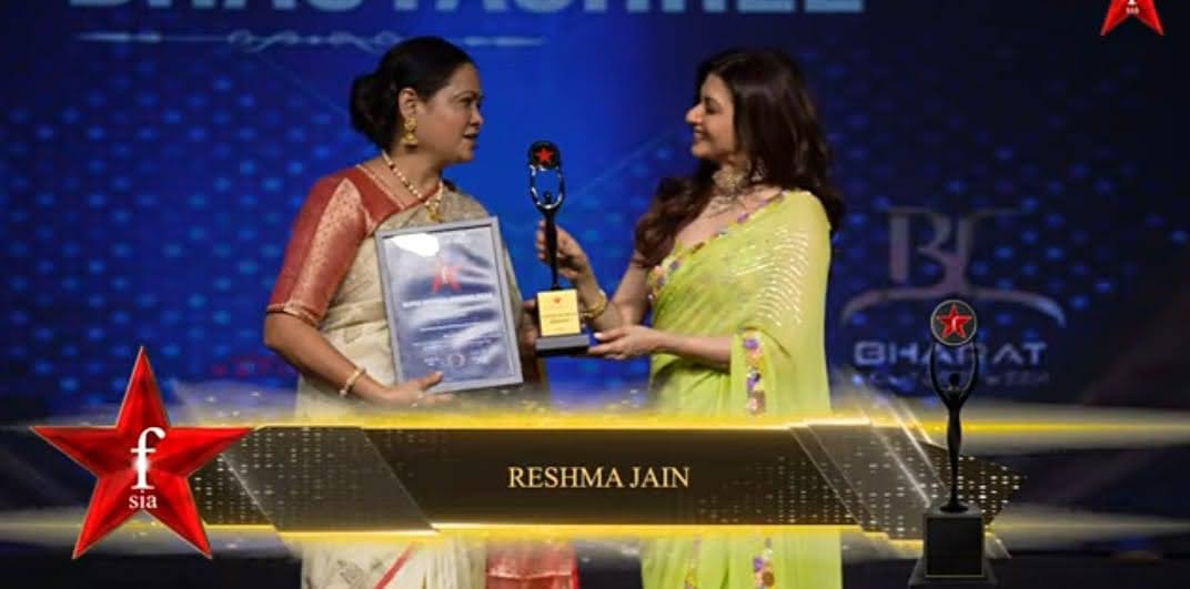 Dr. Reshma Jain receiving an award on stage at an International Women's Day celebration