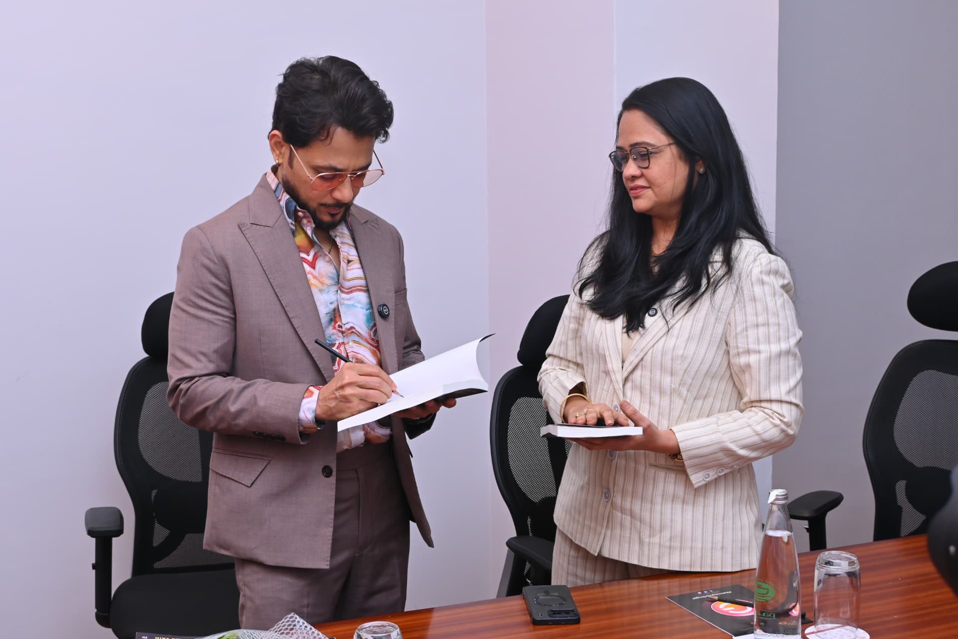 Anupam Mittal signing a copy of Spiritual Wealth Codes