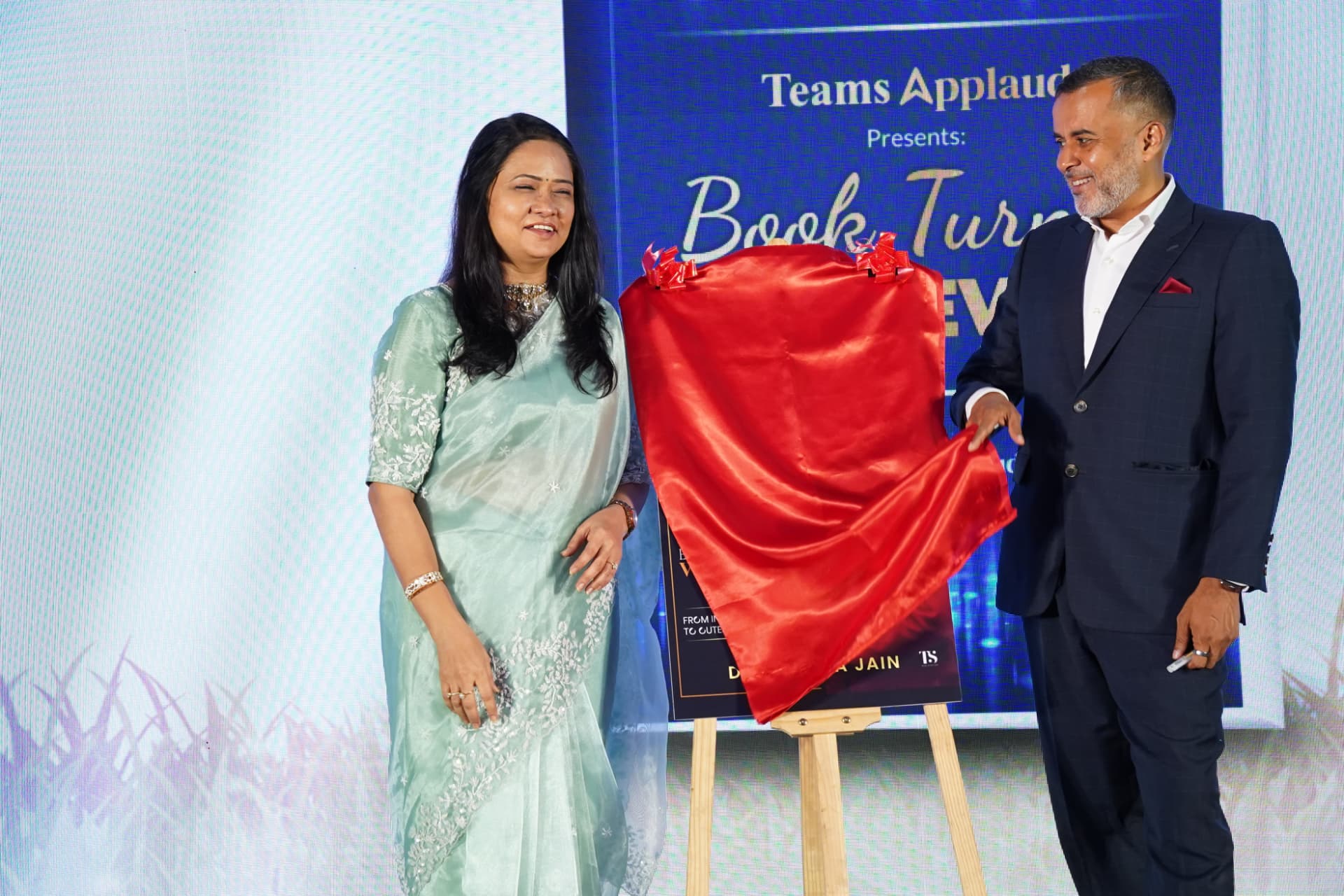 Dr. Reshma Jain unveiling Spiritual Wealth Codes at the book launch with Chetan Bhagat